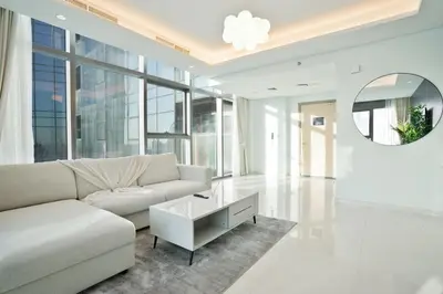 a living room with a couch and a table at 5 Star Stay, Infinity Pool with Burj Khalifa Views in Dubai
