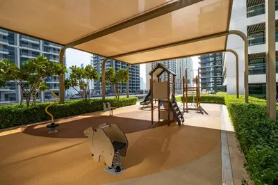 a playground with a slide in a building at Homes Beyond l Relaxing 1BR Oasis with Beach Access in Dubai