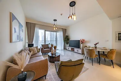 a living room with a couch and a table at Homes Beyond I 1BR Coastal Haven Walk to the Beach in Dubai