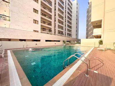 a swimming pool in the middle of a building at Stylish Studio in the Heart of Al Furjan 20AB4 in Dubai