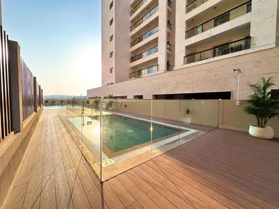 a building with a swimming pool in the middle of a building at Stylish Studio in the Heart of Al Furjan 20AB4 in Dubai