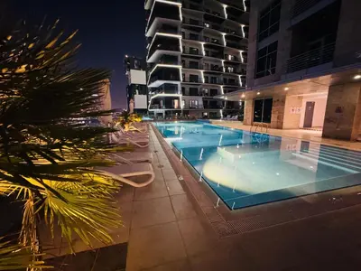 a swimming pool in the middle of a building at night at Premium Large Studio in Hamilton residency business bay Marasi Drive Dubai in Dubai