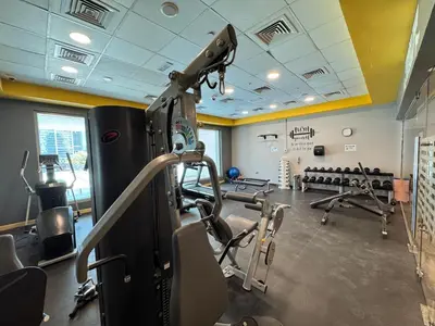 a gym with several treadmills and machines in it at Premium Large Studio in Hamilton residency business bay Marasi Drive Dubai in Dubai