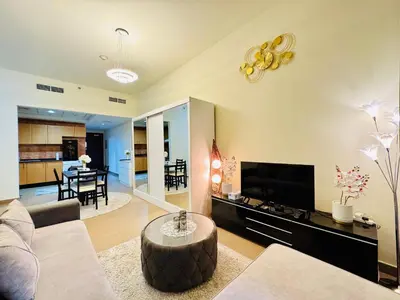 a living room with a couch and a table at Premium Large Studio in Hamilton residency business bay Marasi Drive Dubai in Dubai