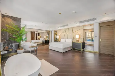 a bedroom with a bed and a living room at Daniels 3BR at Princess Tower With Full Palm Jumeirah View in Dubai