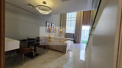 a living room with a couch and a table at 1 bed townhouse in Dubai