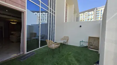 a balcony with chairs and a table on a building at 1 bed townhouse in Dubai