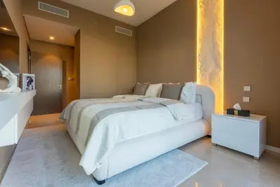 a bedroom with a large white bed in a room at Stunning Burj Khalifa & Fountain Views - Luxury 2BR - 5 minutes walk to Dubai Mall in Dubai
