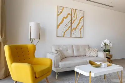 a living room with a yellow chair and a couch at Modern 1Br in the Heart of Dubai by SIMPLY COMFORT in Dubai