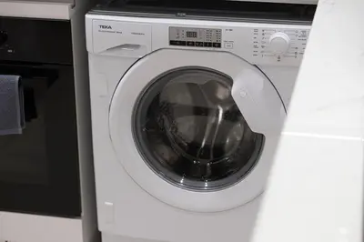 a white washing machine sitting next to a microwave at Brand New Apt On Top Floor 1BR w Spa And Pool in Dubai