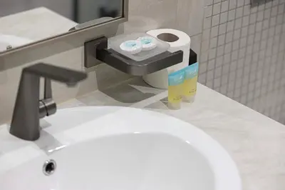 a bathroom with a white sink and a toilet at New 1BR APT Business Bay w Burj View in Dubai
