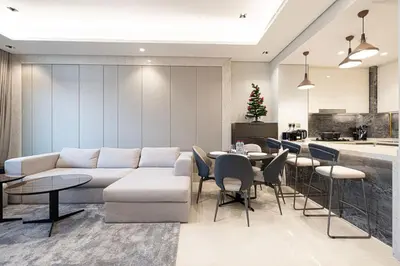 a living room with a couch and a table with chairs at New 1BR APT Business Bay w Burj View in Dubai
