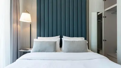 a bedroom with a large bed with white pillows at Keyrock Living - Lakeview Retreat in Business Bay in Dubai
