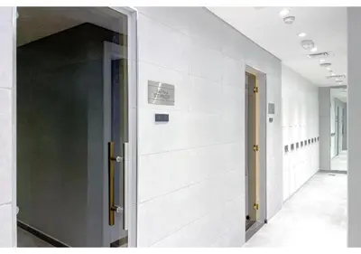 a hallway with white walls and an open door at Keyrock Living - Lakeview Retreat in Business Bay in Dubai