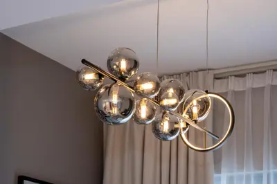 a brass chandelier hanging from a ceiling at Keyrock Living - Lakeview Retreat in Business Bay in Dubai
