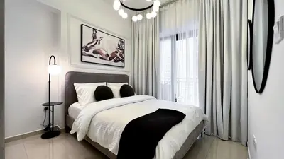 a white bedroom with a bed and a window at Exclusive Lakeview Haven - Zada Tower by Keyrock Living in Dubai
