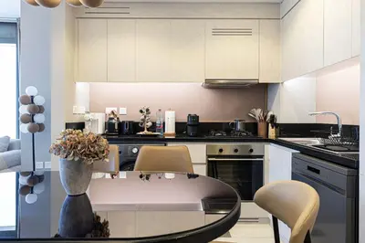 a kitchen with a table and chairs in a room at Modern 3-Bedroom Apartment with Breathtaking City Views in Dubai