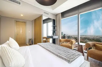 a bedroom with a white bed and a large window at Modern 3-Bedroom Apartment with Breathtaking City Views in Dubai