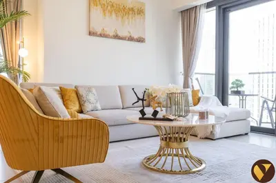 a living room with a couch and a table at Vogue Downtown Act One near Burj Khalifa and Dubai Mall, Two Bedroom Apartment with Balcony and City Skyline View, Access to All Amenities in Dubai