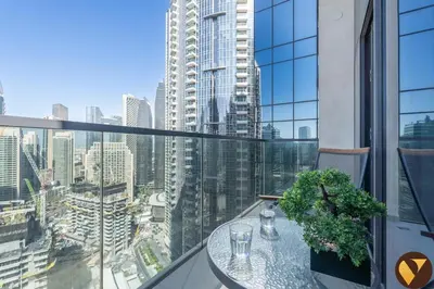 a balcony with a table and a view of a city at Vogue Downtown Act One near Burj Khalifa and Dubai Mall, Two Bedroom Apartment with Balcony and City Skyline View, Access to All Amenities in Dubai