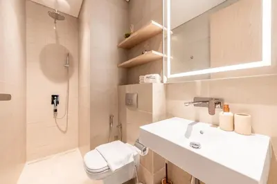 a bathroom with a sink and a toilet and a shower at Serene 2BRplus1 Haven in Oakley JVC - 5star Amenities in Dubai