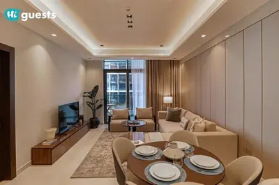 a living room with a couch and a table at HiGuests - Stylish 1BR Retreat with Modern Interiors in Dubai in Dubai