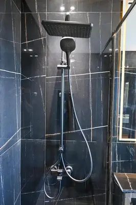 a shower with a shower head in a bathroom at Pure Voyage JVC in Dubai