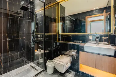 a bathroom with a toilet and a sink and a shower at Pure Voyage JVC in Dubai