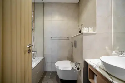 a bathroom with a toilet and a sink at UrbanStays Dubai - Paramount Midtown in Dubai