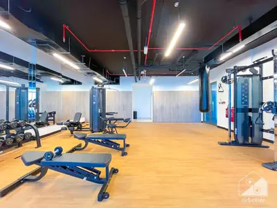 a gym with a bunch of treadmills and machines at Luxurious Studio in Arjan With Balcony & Views in Dubai