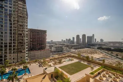 a view of a city with tall buildings and a park at Frank Porter - Damac Ghalia in Dubai