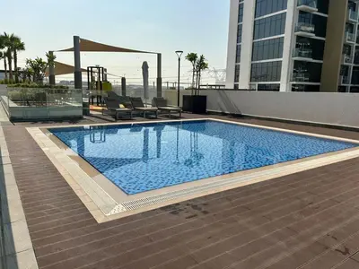 a large swimming pool on top of a building at Modern Studio Near Burj Khalifa in Dubai