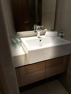 a bathroom with a white sink and a mirror at Modern Studio Near Burj Khalifa in Dubai