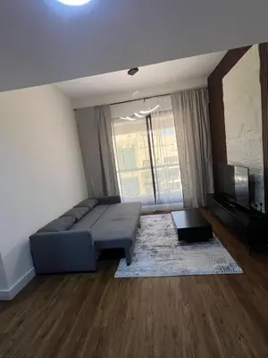 a living room with a couch and a large window at Dubai Marina Escan Tower Family Apartment in Dubai