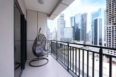a balcony with a view of a city skyline at Keyrock Living - Lakeview Luxury with Pool Access in Dubai