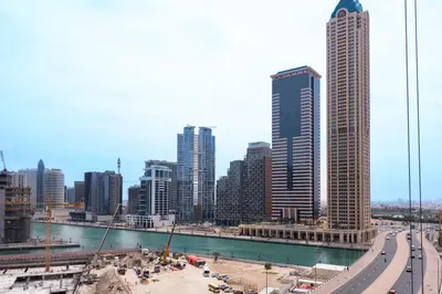 a city skyline with tall buildings and a river at Keyrock Living - Lakeview Luxury with Pool Access in Dubai