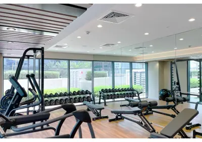a gym with a lot of treadmills and machines at Keyrock Living - Lakeview Luxury with Pool Access in Dubai