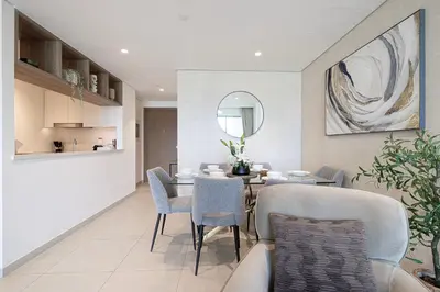 a dining room with a table and chairs at Beautiful 2BR - Burj Views And Dubai Mall Connection in Dubai