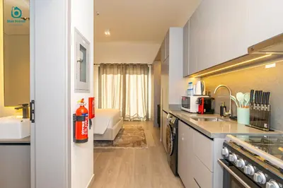 a kitchen with a sink and a counter top at Blue Breeze - Stylish Studio Retreat in MBR City in Dubai