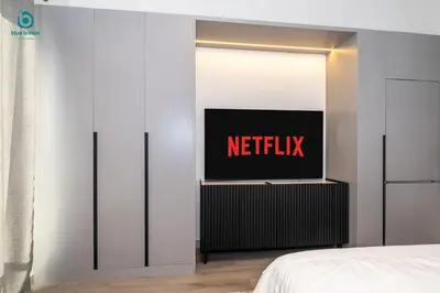 a hotel room with a netflix sign on the wall at Blue Breeze - Stylish Studio Retreat in MBR City in Dubai