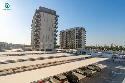 an architectural rendering of a parking lot with two tall buildings at Blue Breeze - Stylish Studio Retreat in MBR City in Dubai