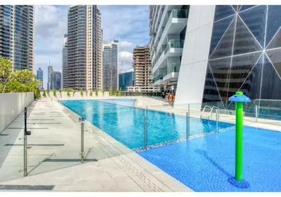 a large swimming pool in a city with tall buildings at Keyrock Damac Maison Privée - Studio in Business Bay with Pool, Gym & Free Parking in Dubai