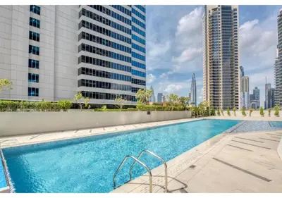 a swimming pool on a building with tall buildings at Keyrock Damac Maison Privée - Studio in Business Bay with Pool, Gym & Free Parking in Dubai