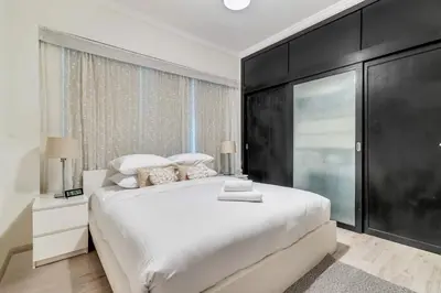 a bedroom with a large white bed and a window at GuestReady - Contemporary haven in Dubai Marina in Dubai