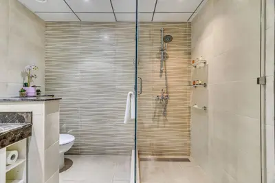 a bathroom with a glass shower with a toilet at GuestReady - Contemporary haven in Dubai Marina in Dubai