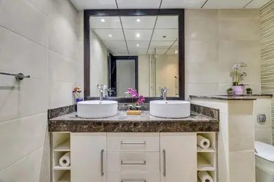 two sinks in a bathroom with a mirror at GuestReady - Contemporary haven in Dubai Marina in Dubai