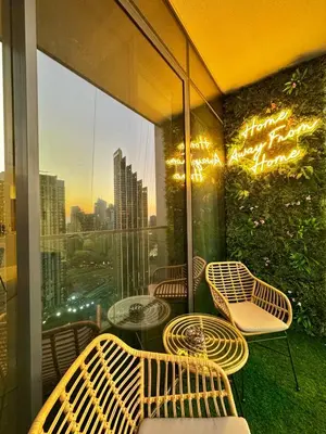 a balcony with chairs and tables and a view of a city at Stunning 1BR Burj View from Infinity Pool in Dubai