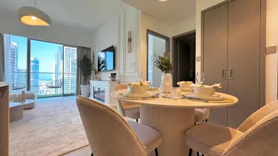 a kitchen and dining room with a table and chairs at Stunning 1BR Burj View from Infinity Pool in Dubai