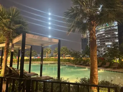 a swimming pool with palm trees in a building at 2 Bedroom Fully Furnished- Aykon City Tower C in Dubai