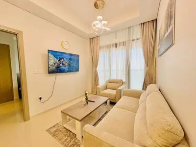 a living room with a couch and a table at 2 Bedroom Fully Furnished- Aykon City Tower C in Dubai